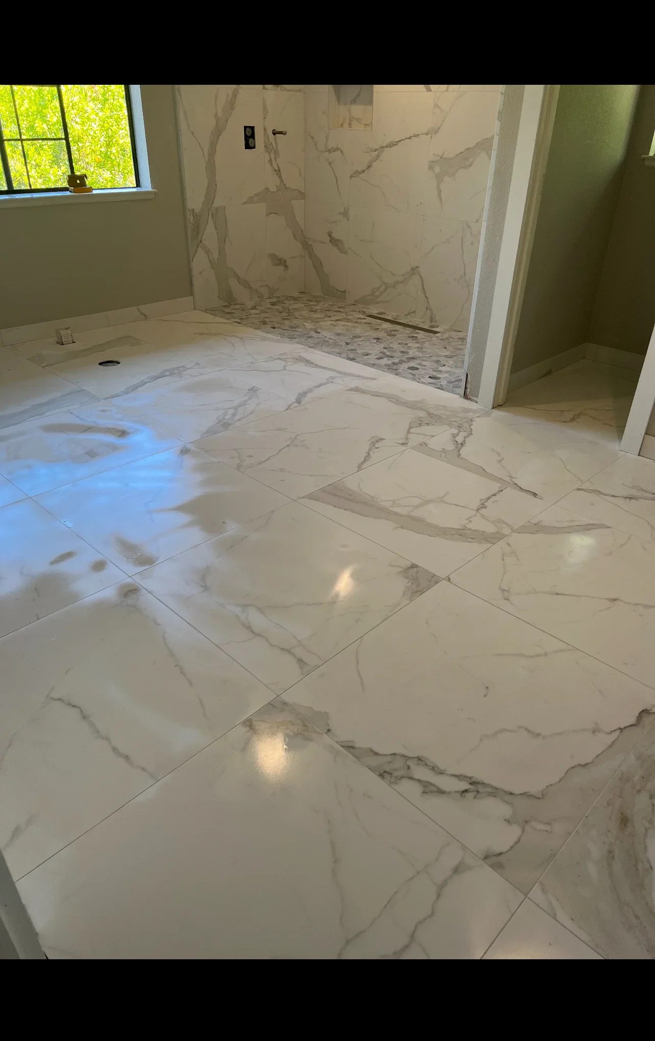 Marble-look porcelain tile flooring and shower walls in bathroom renovation