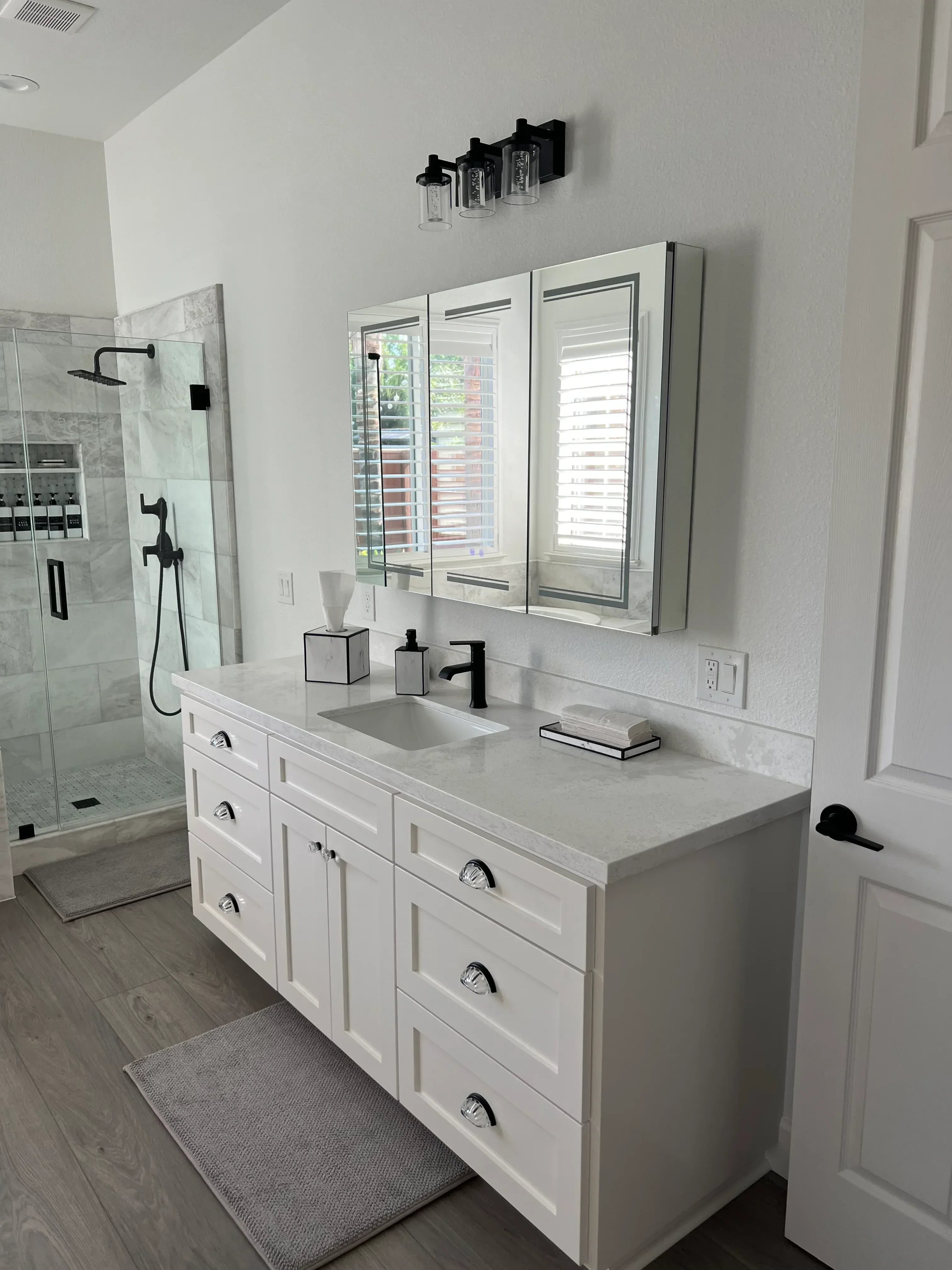 White cabinetry, marble tile floor, recessed lights, and transom windows in renovated kitchen